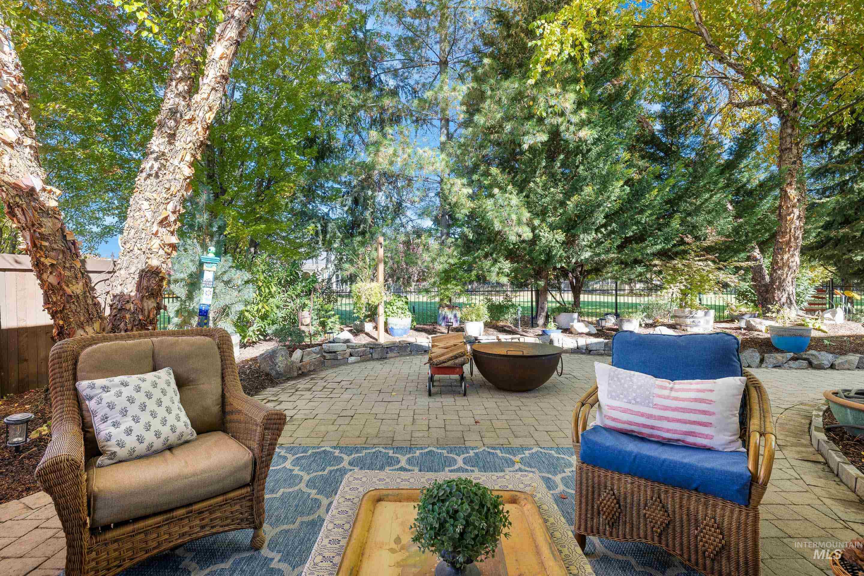 Fenced backyard with a patio and an outdoor living space with a fire pit