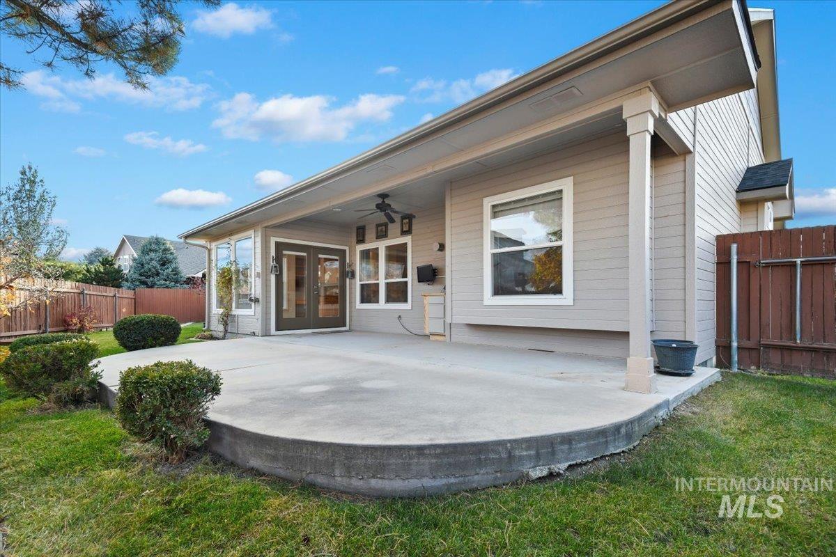 Back of house with ceiling fan, a patio, and french doors