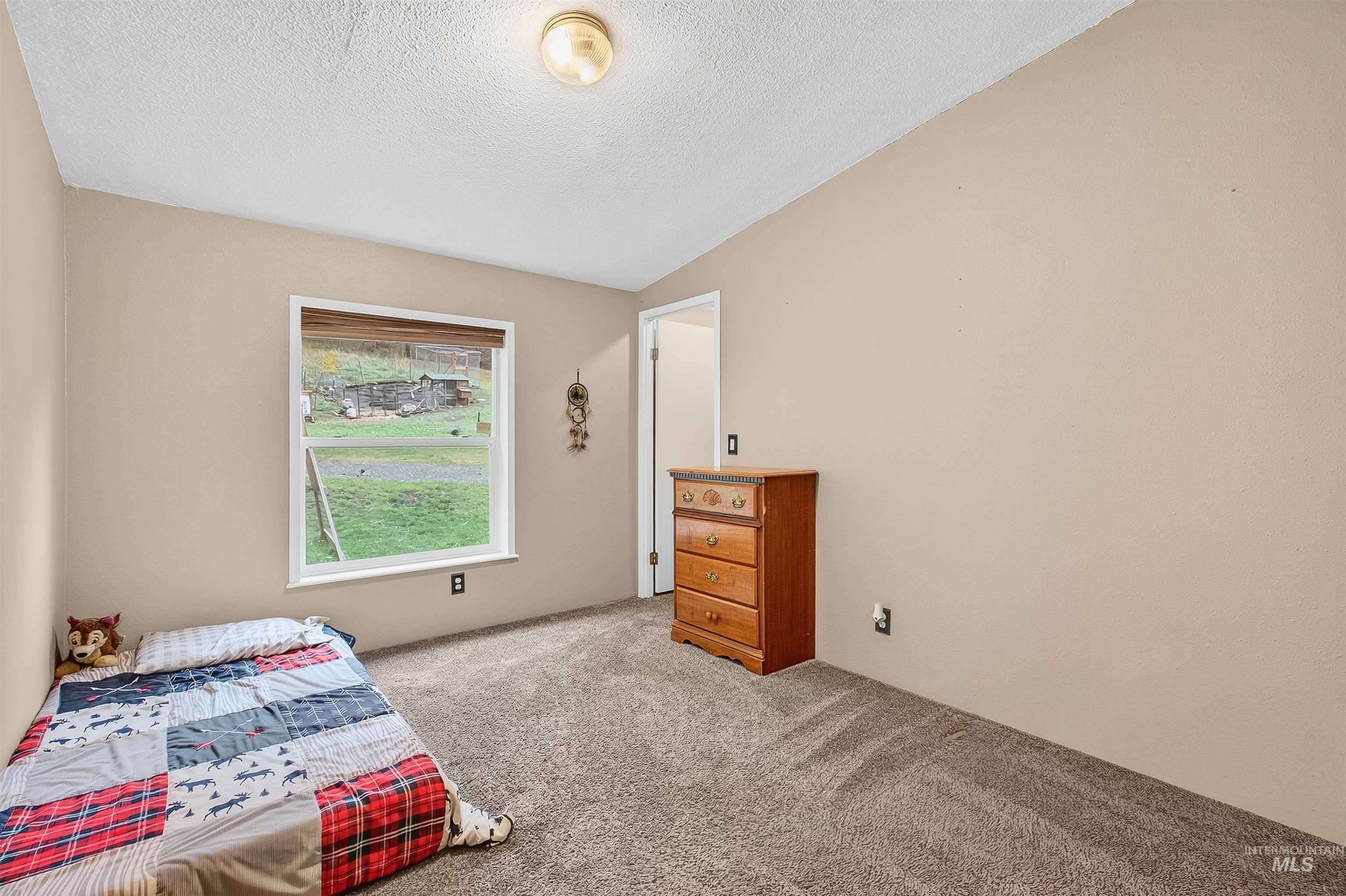 Carpeted bedroom featuring a textured ceiling