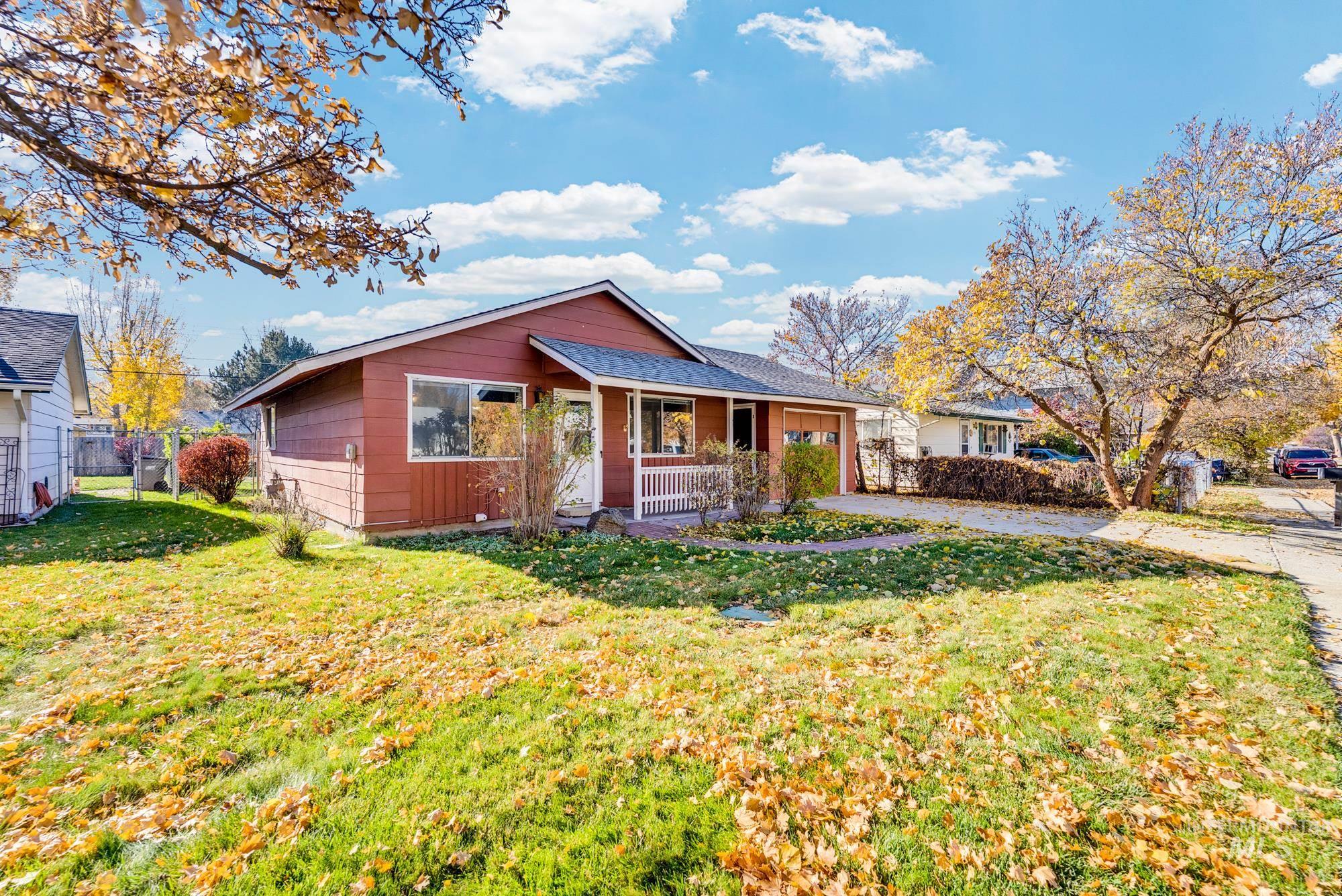 View of front facade with covered porch, a garage, and driveway