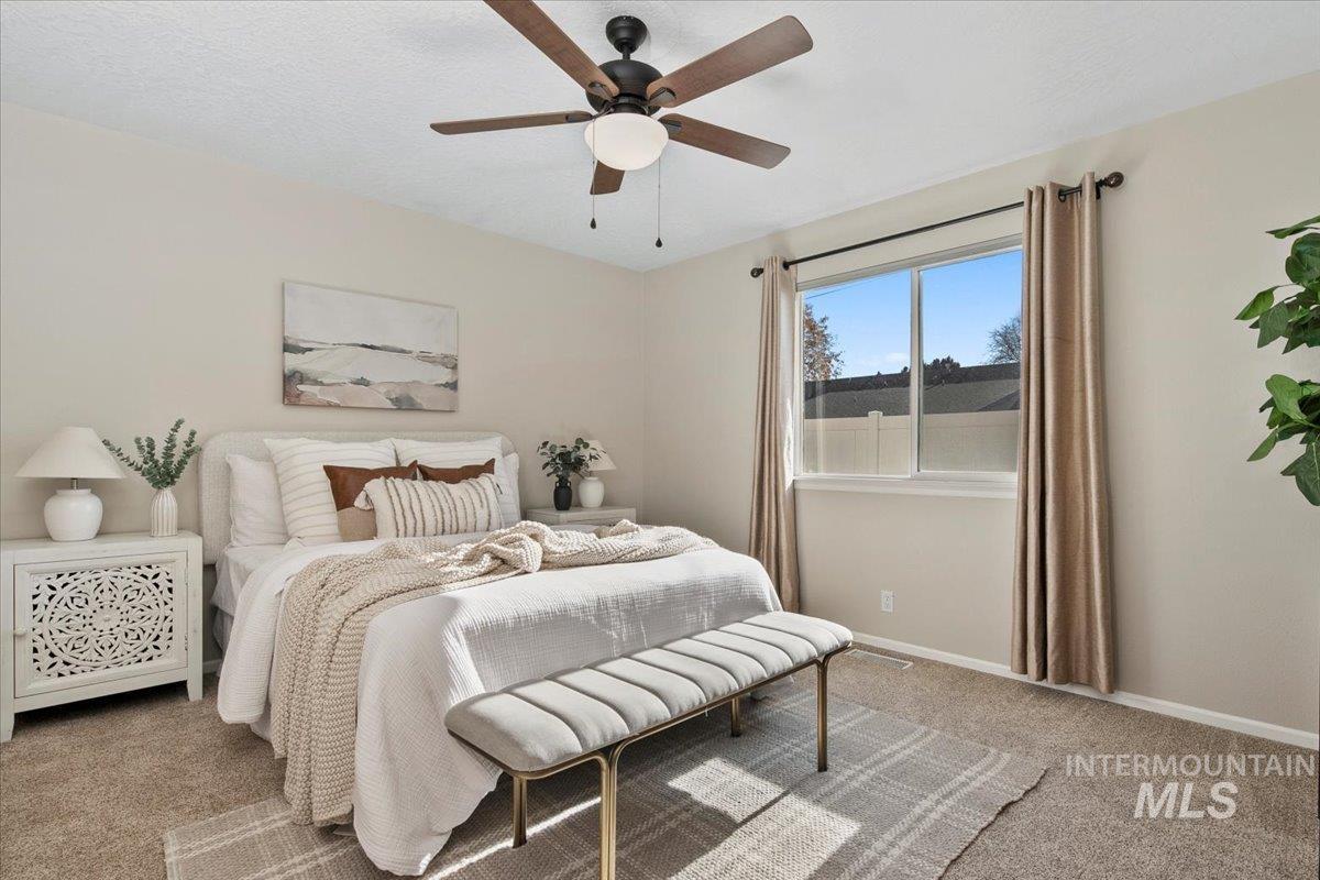 Bedroom with light carpet and ceiling fan
