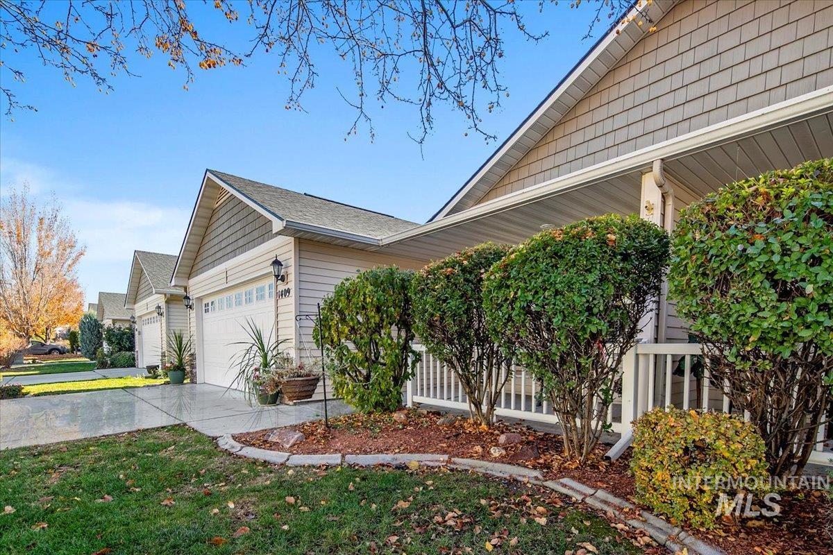 View of home's exterior with a garage and driveway