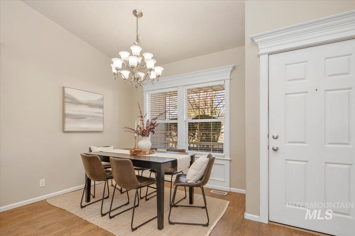 Dining room featuring wood finished floors and a chandelier