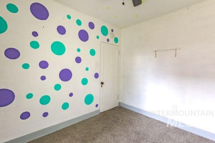 Spare room with carpet floors and a ceiling fan