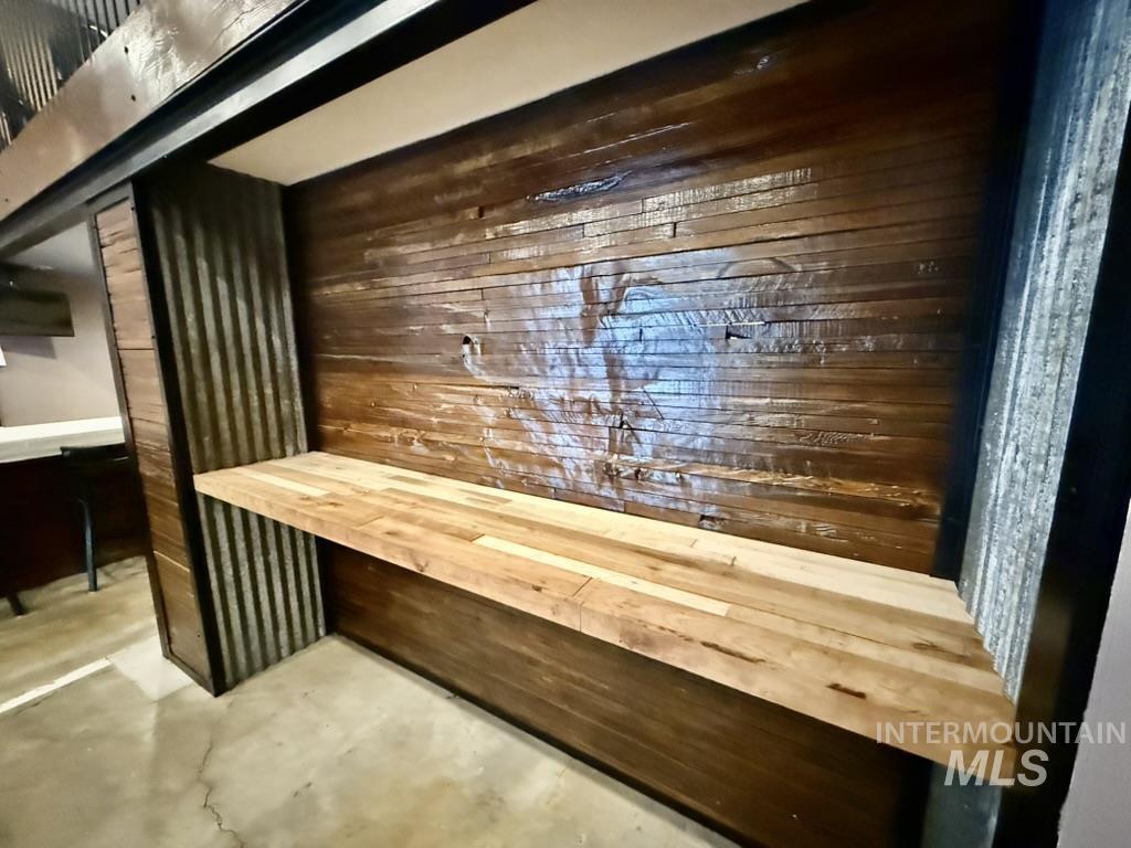 Bar with a sauna / steam room, wood walls, and wooden counters