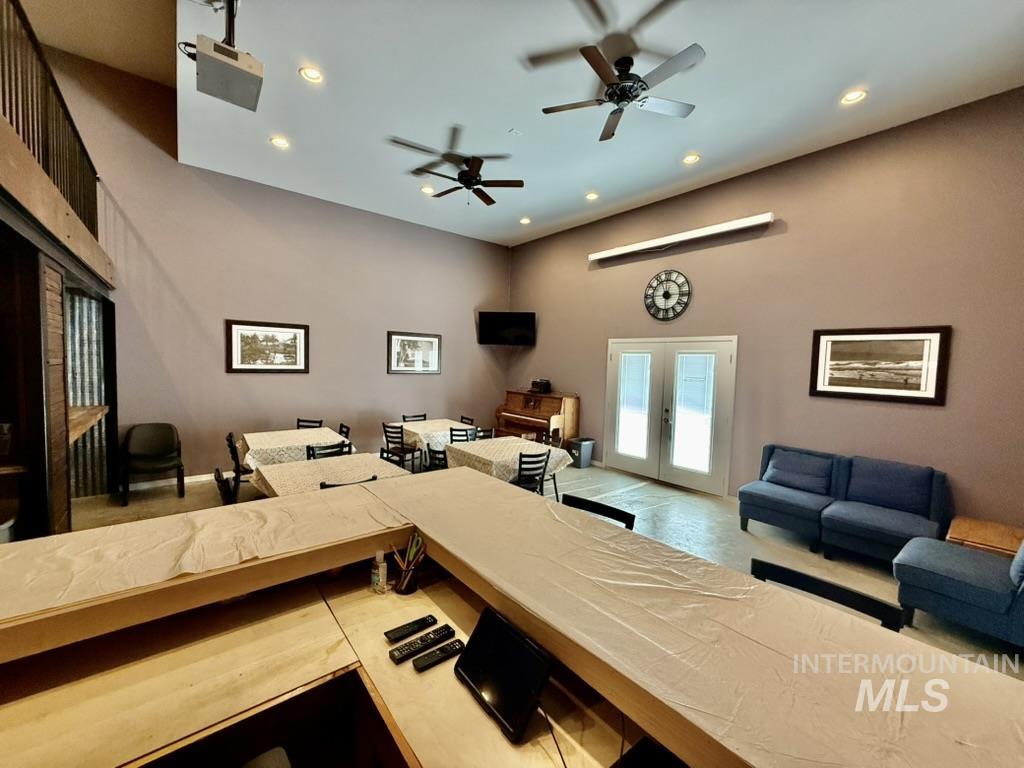Living area with ceiling fan, recessed lighting, and french doors