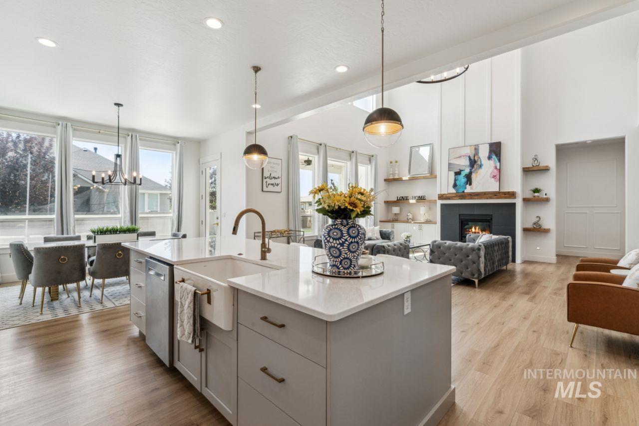Kitchen featuring a chandelier, light wood-style floors, gray cabinetry, light countertops, and recessed lighting