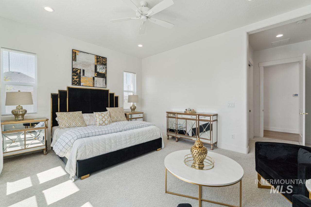 Carpeted bedroom with recessed lighting and ceiling fan