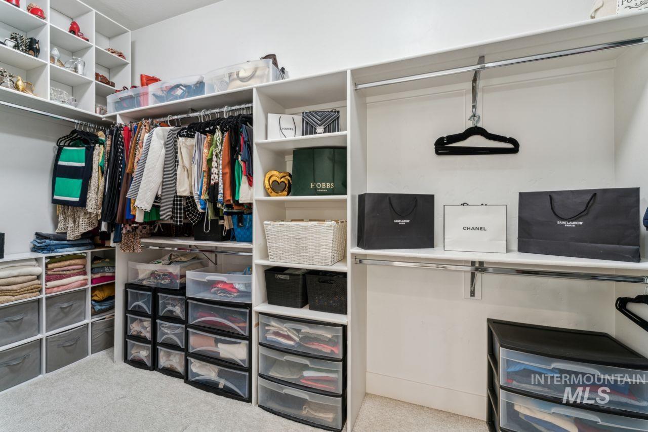Spacious closet featuring carpet flooring