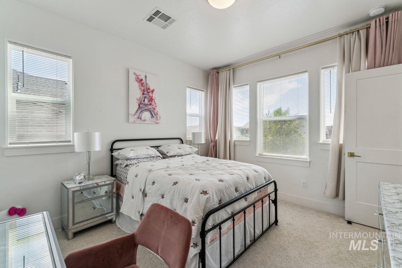 Bedroom featuring light carpet and baseboards
