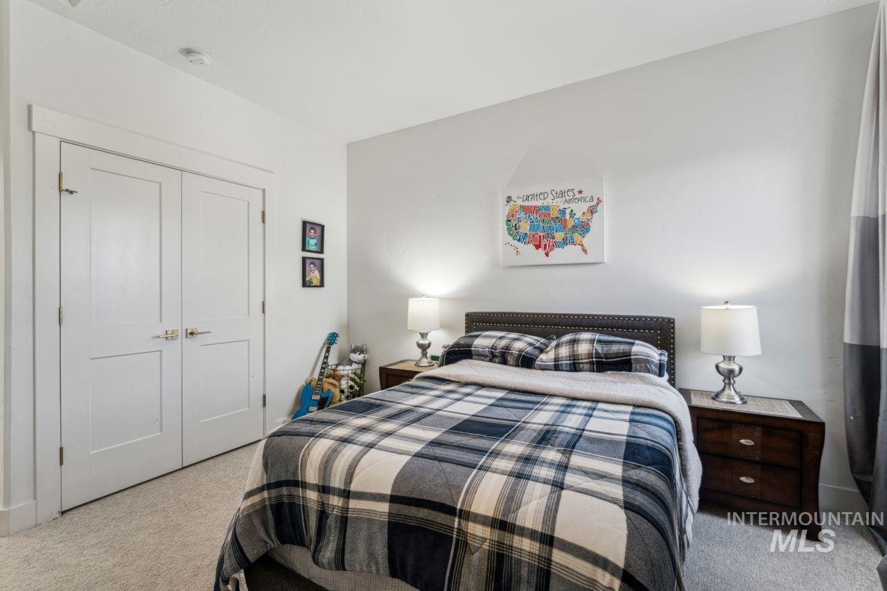 Carpeted bedroom featuring a closet