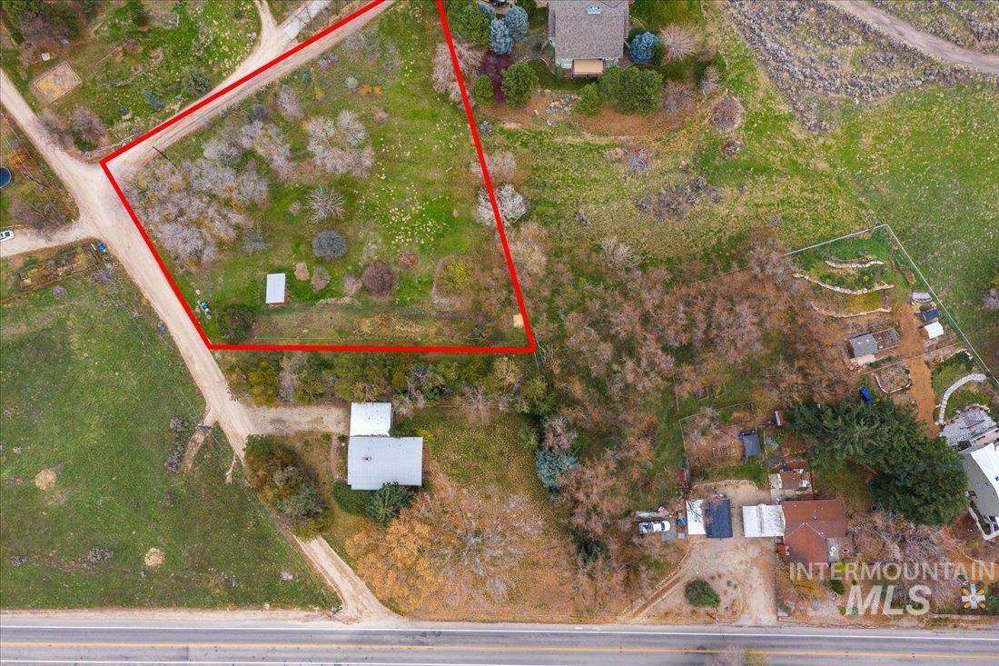 Aerial view of property and surrounding area featuring property boundaries highlighted