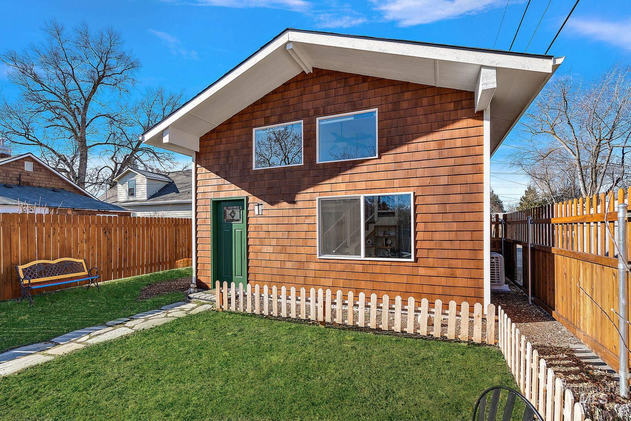 Rear view of house with a fenced backyard