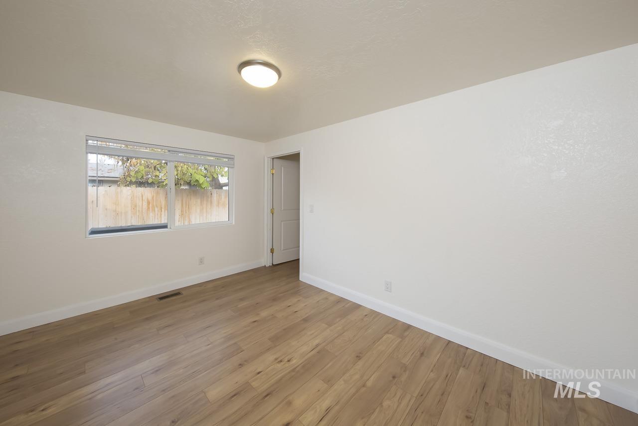 Spare room with wood finished floors and baseboards