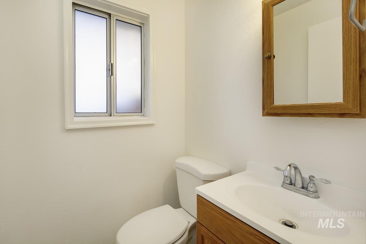 Half bathroom with vanity and toilet