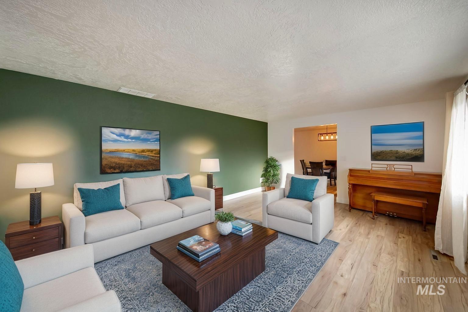 Living room with light wood finished floors and a textured ceiling