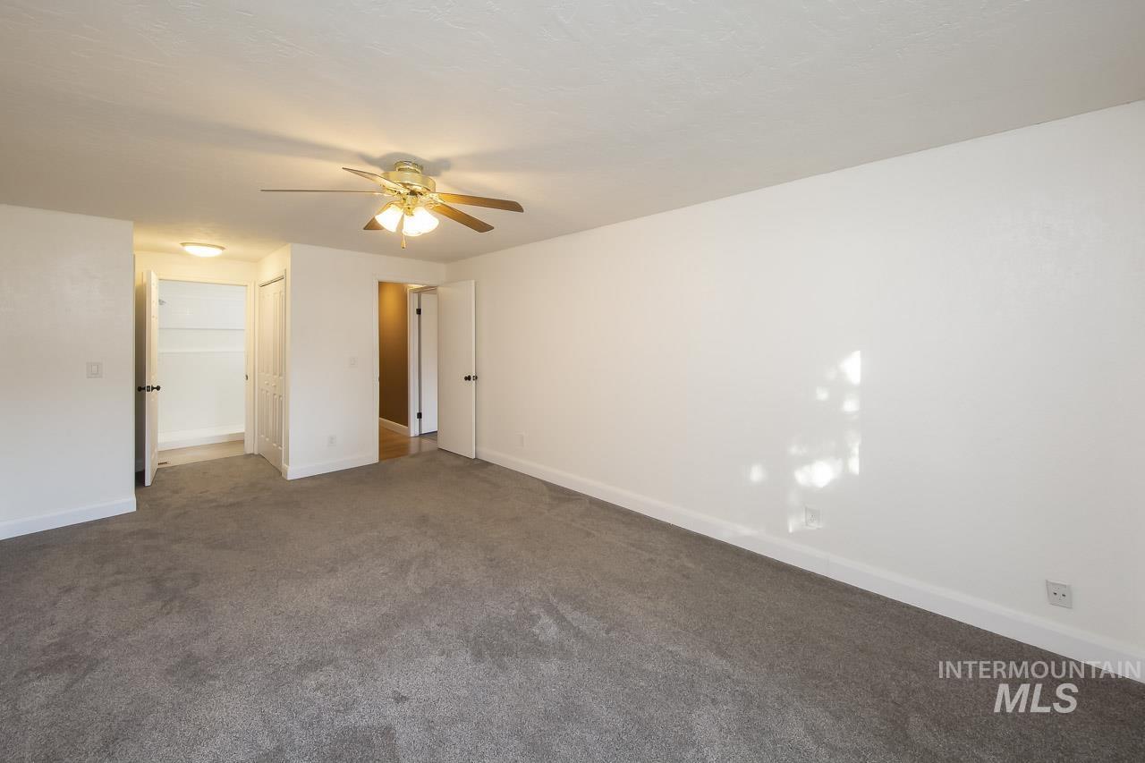Unfurnished bedroom with carpet flooring, ceiling fan, and a closet