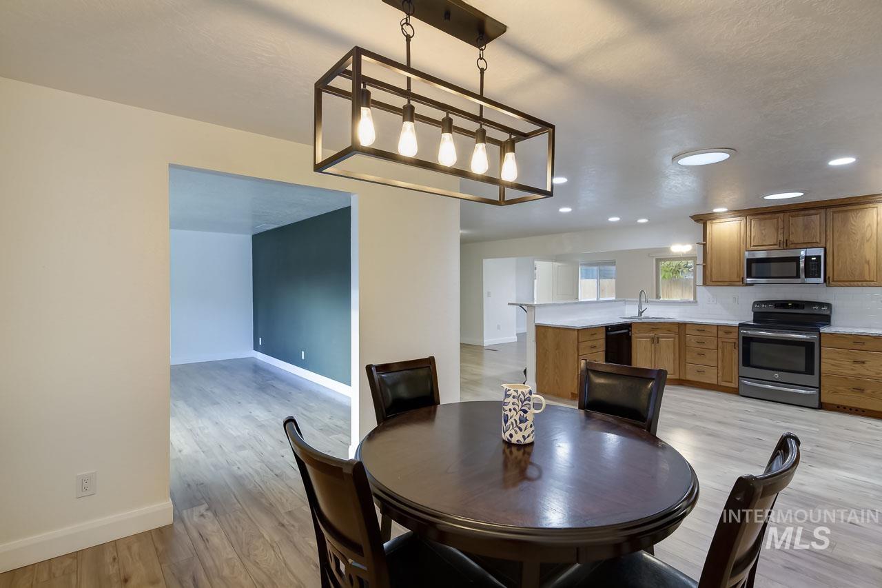 Dining area featuring light wood-style flooring and recessed lighting