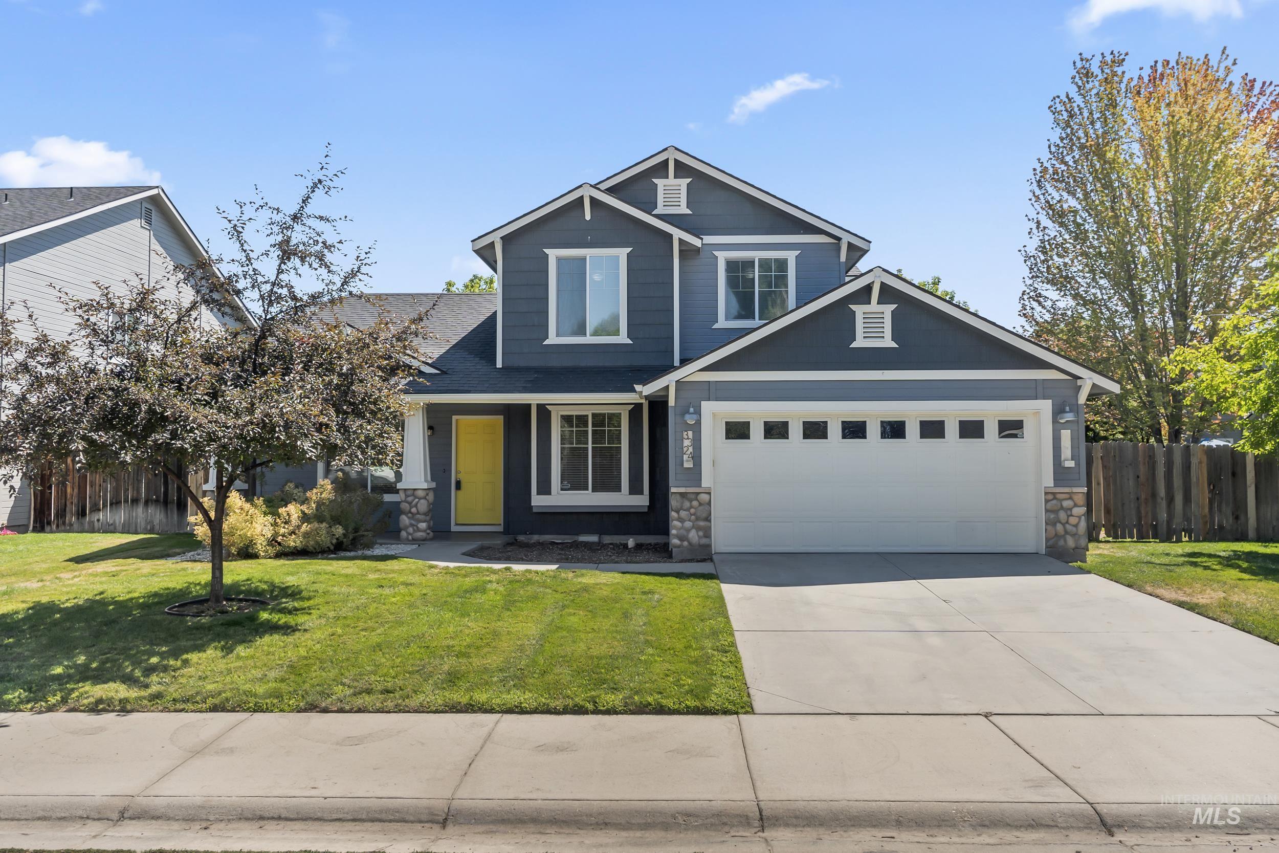 Craftsman inspired home featuring stone siding, concrete driveway, and an attached garage