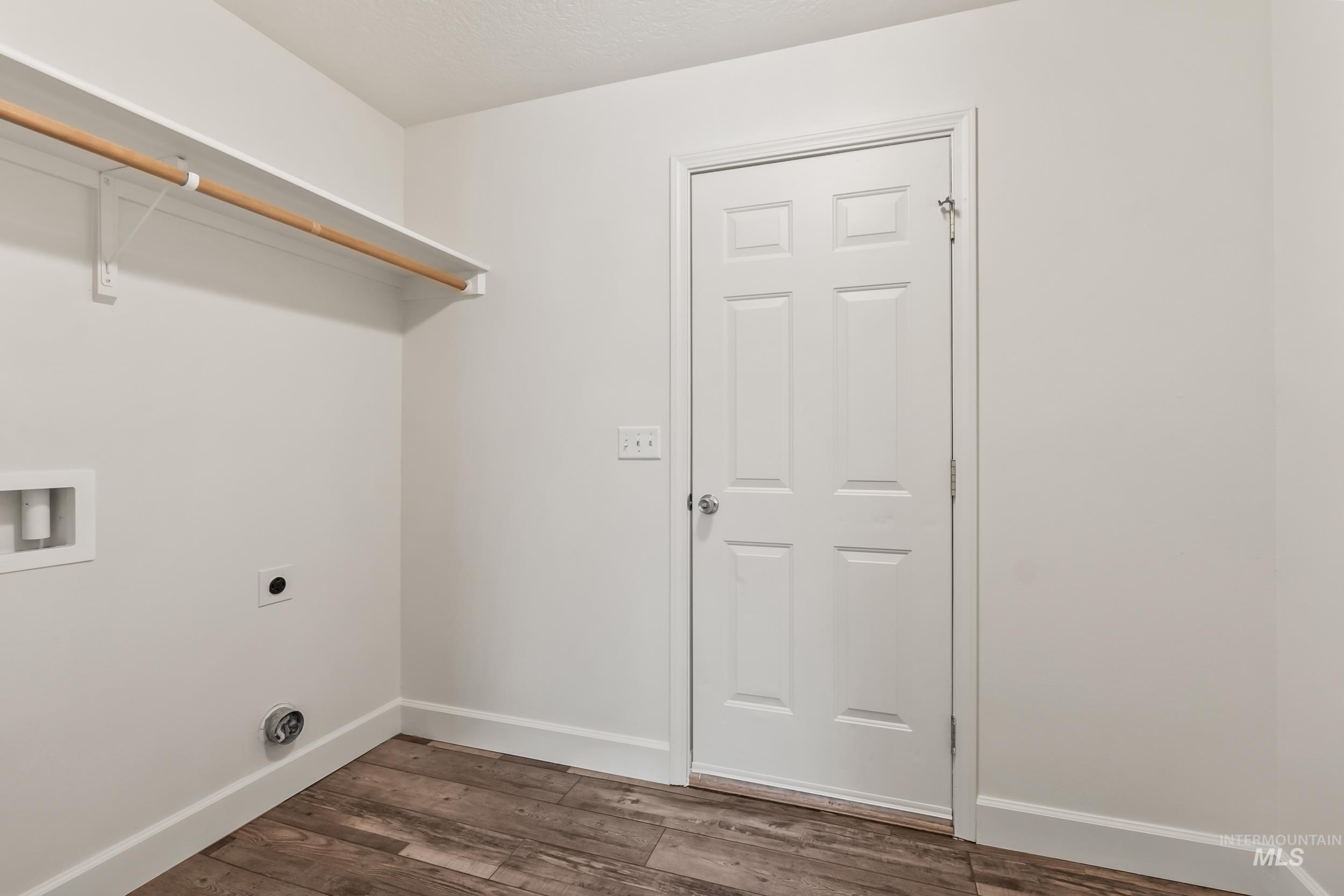 Washroom featuring dark wood-style floors, hookup for a washing machine, and hookup for an electric dryer