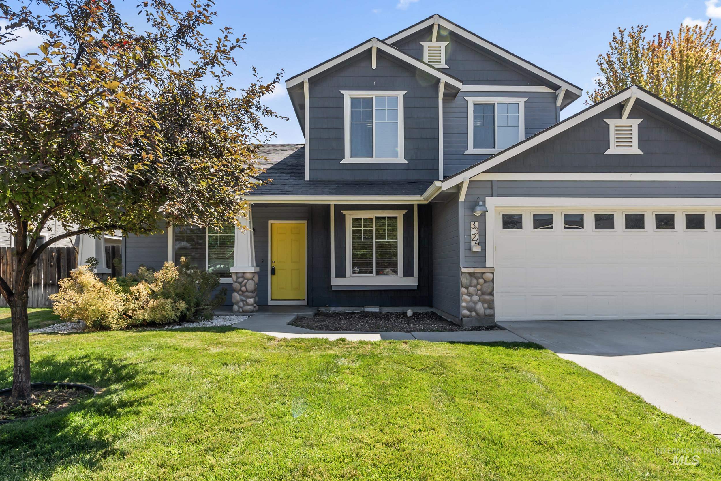 Craftsman inspired home featuring stone siding, driveway, and a shingled roof
