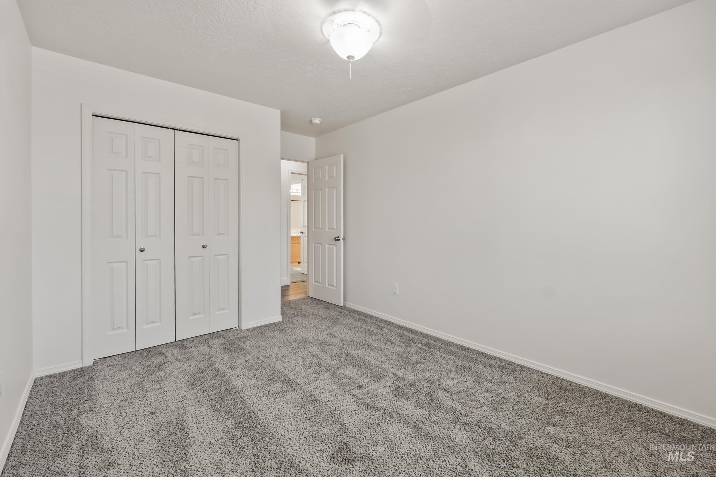 Unfurnished bedroom featuring carpet floors and a closet