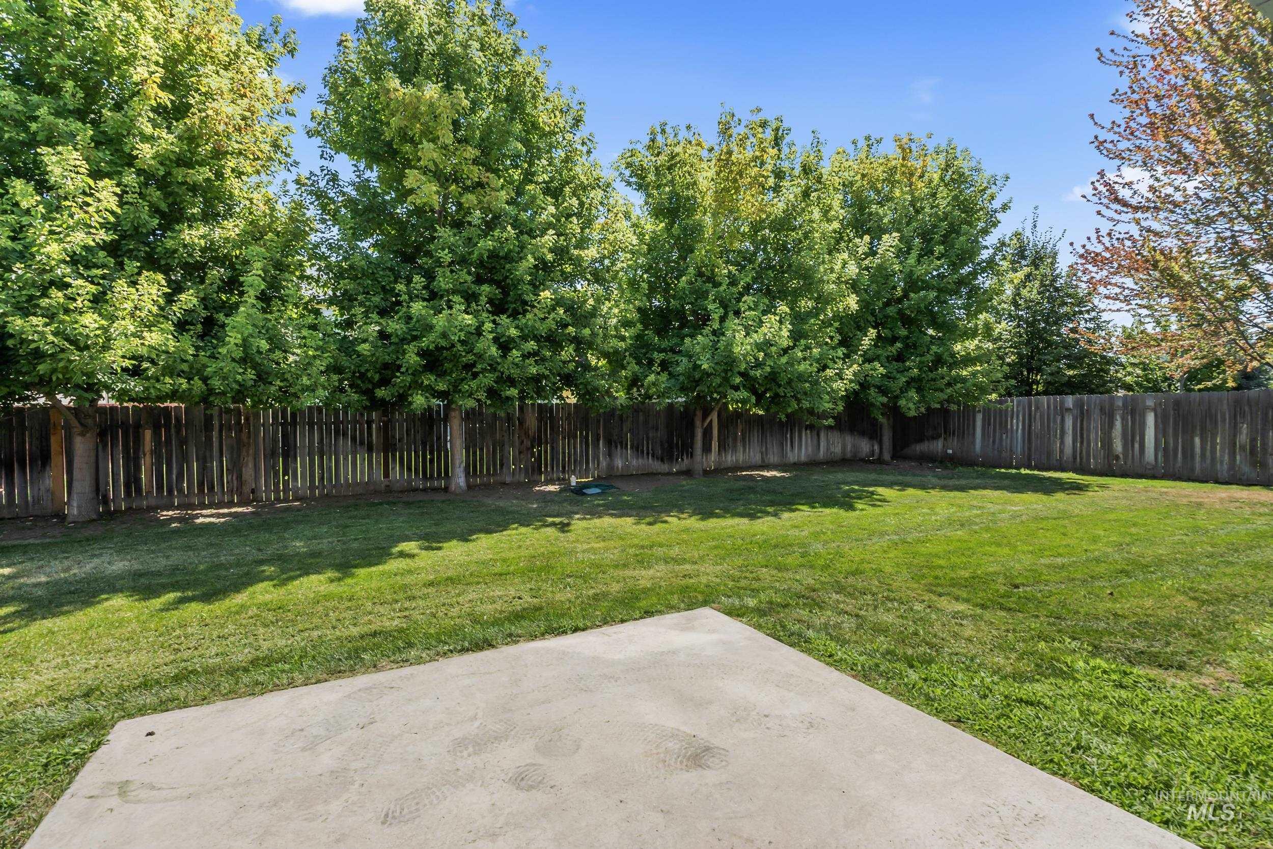 Fenced backyard with a patio