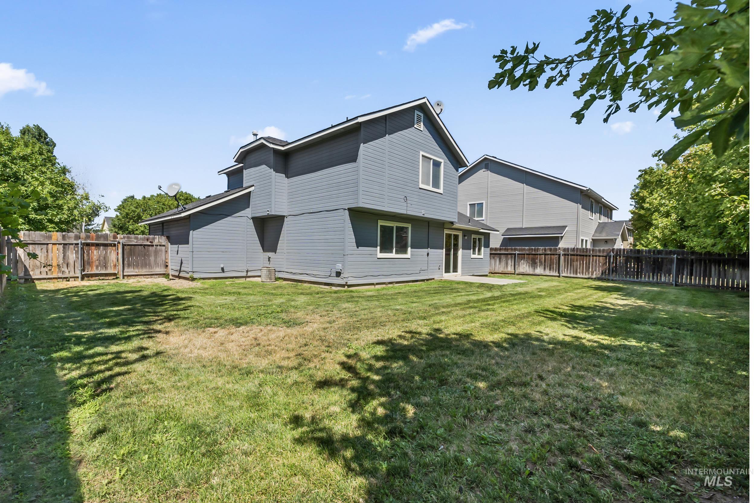 Rear view of property featuring a fenced backyard and a patio area