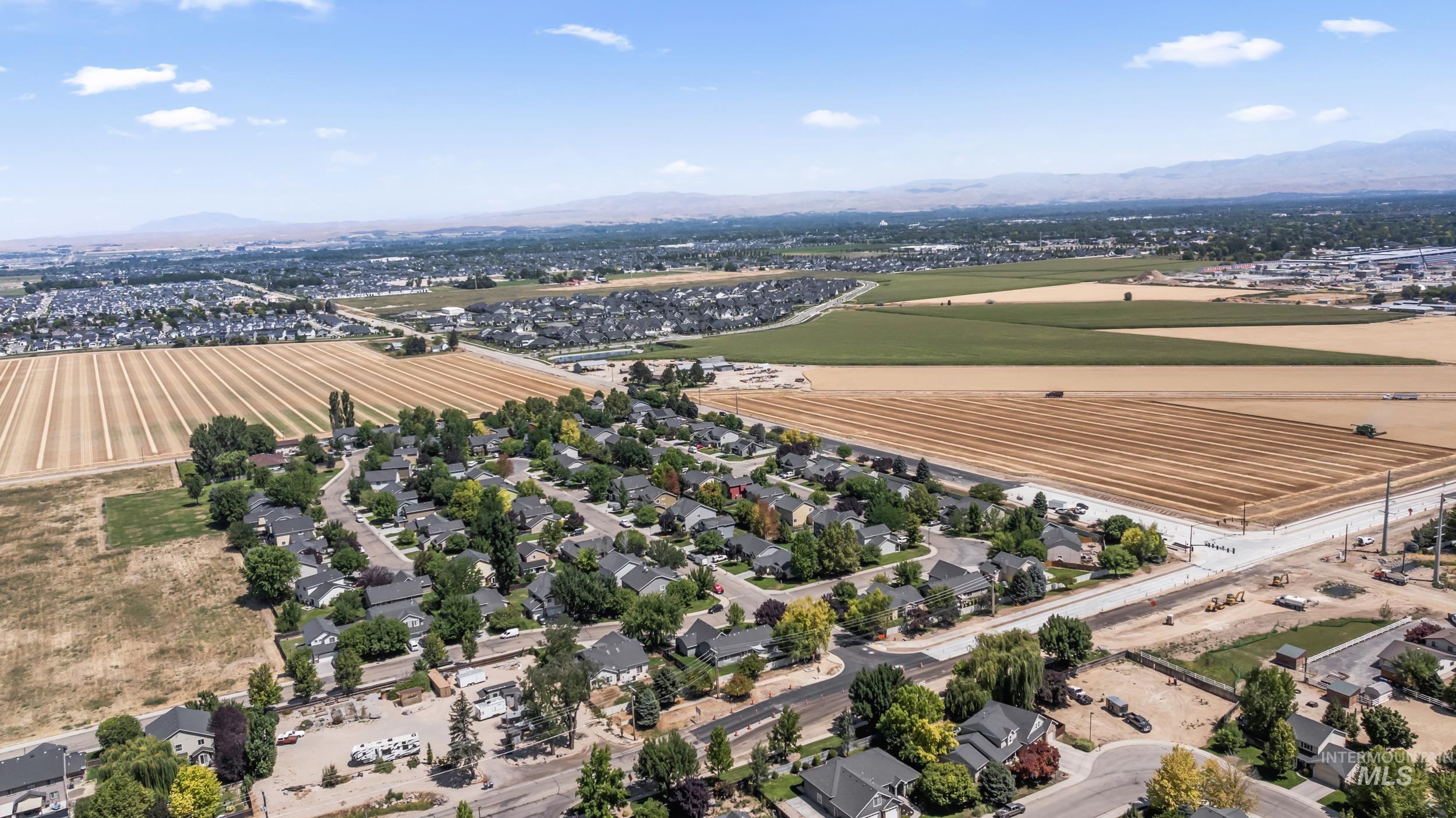 Aerial perspective of suburban area with a mountain backdrop