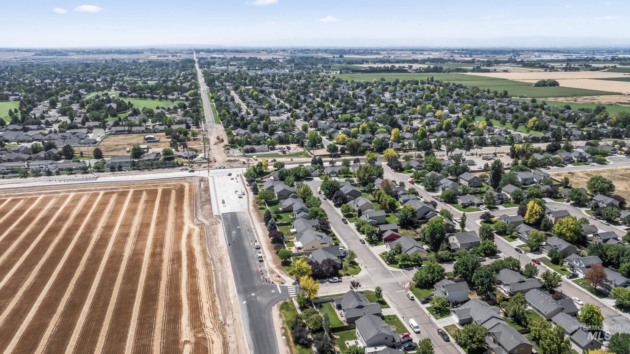 Aerial view of property's location with nearby suburban area