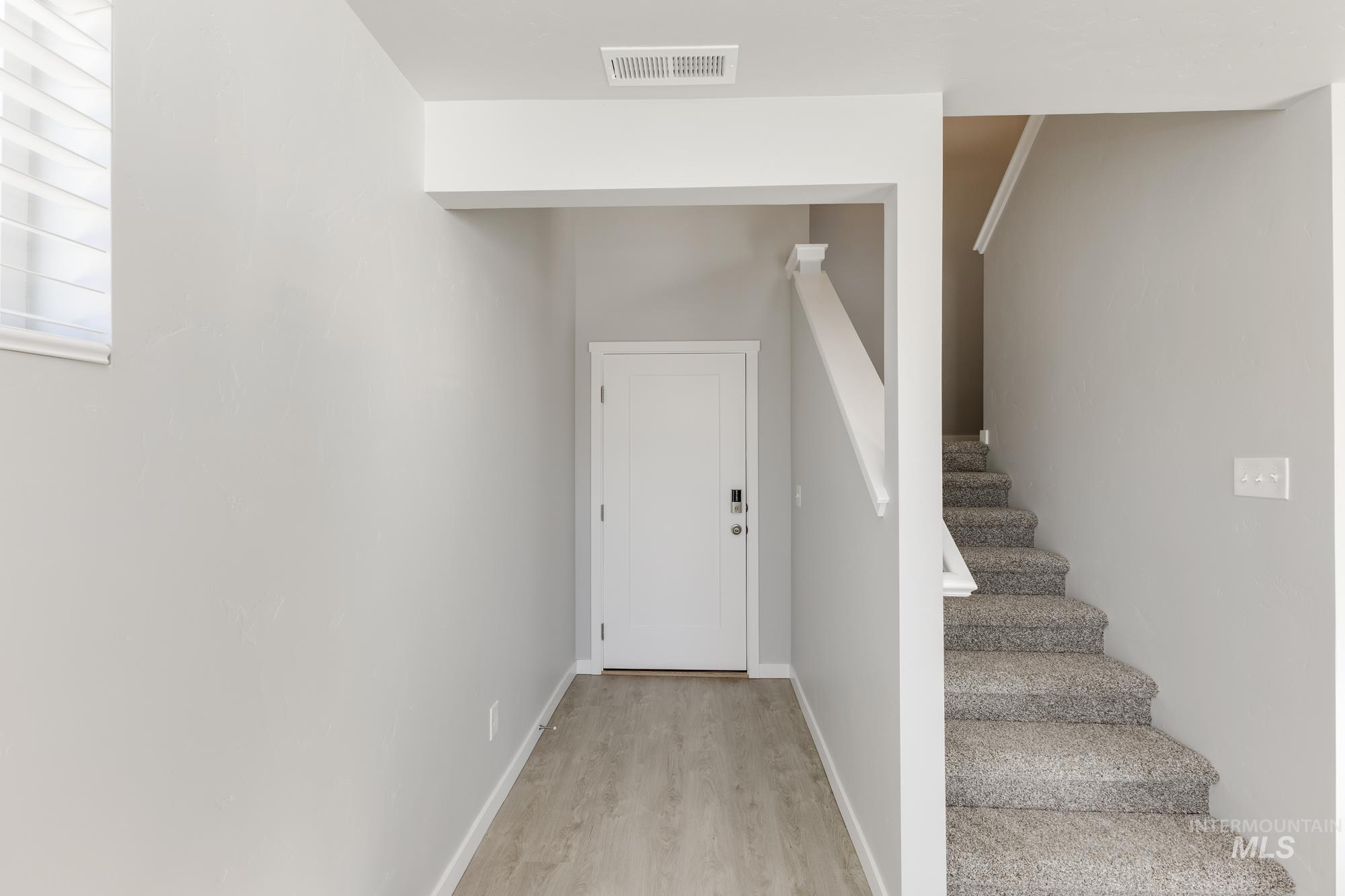 Staircase featuring wood finished floors and baseboards