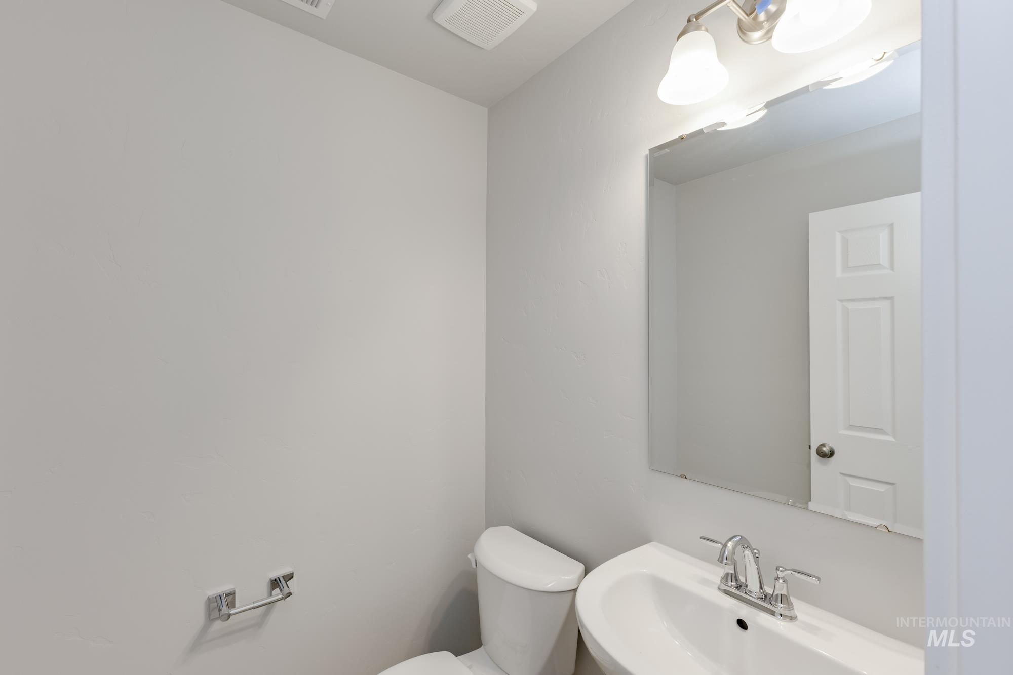 Half bathroom featuring a sink and toilet