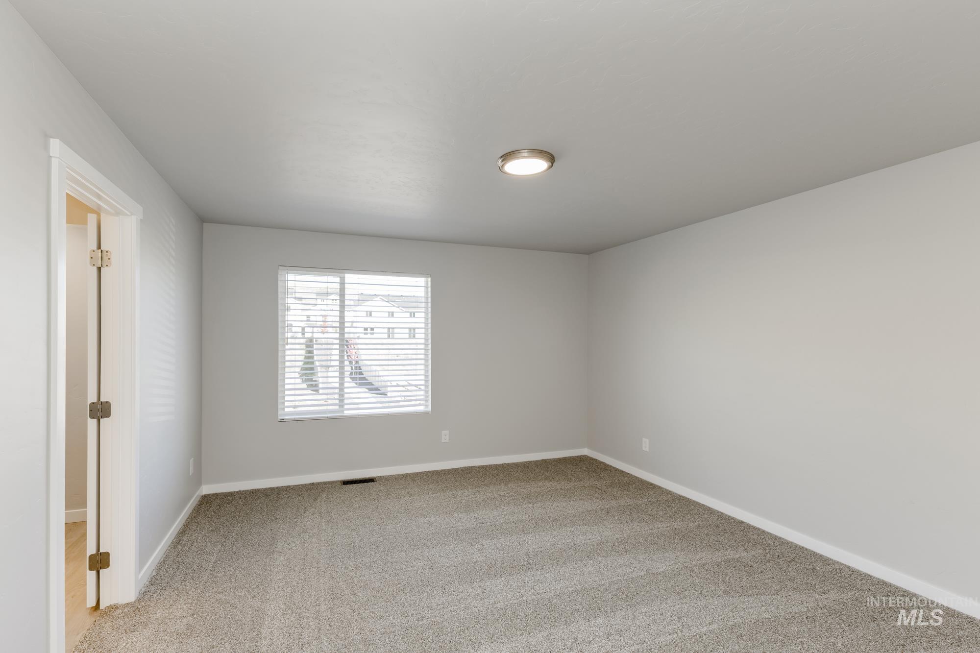 Unfurnished room featuring light carpet