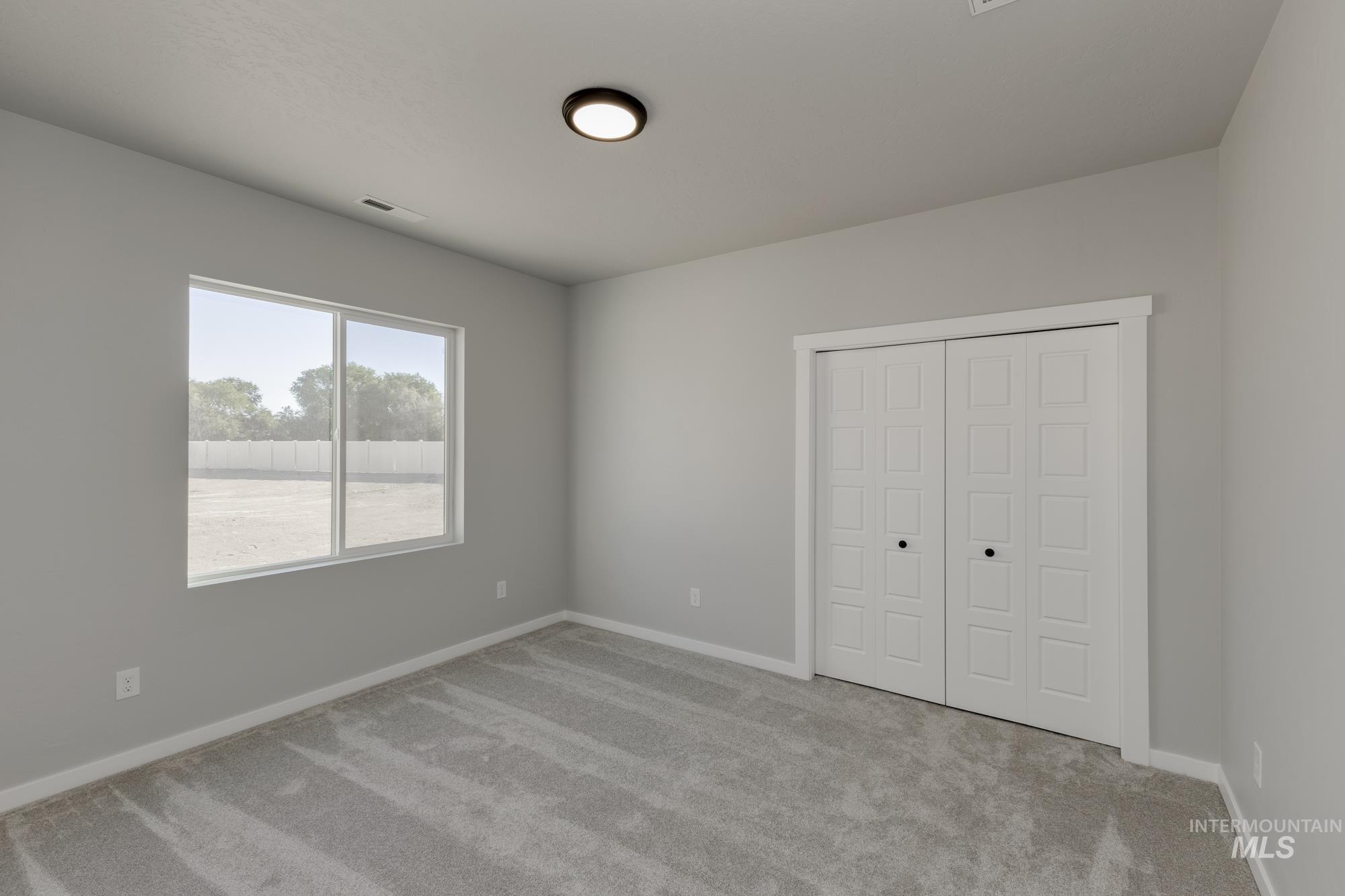 Unfurnished bedroom with carpet flooring and a closet