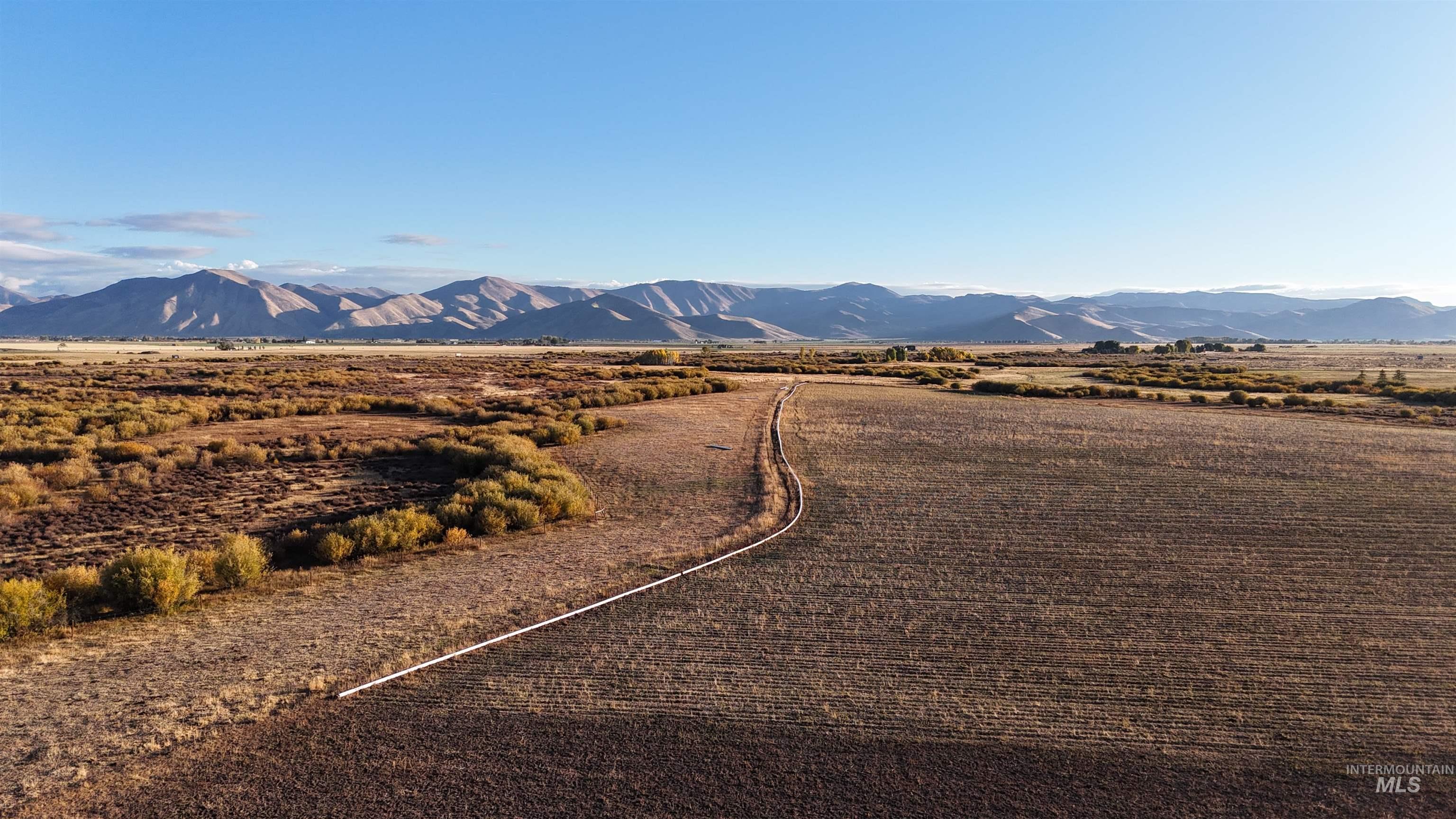 View of mountain backdrop with rural landscape