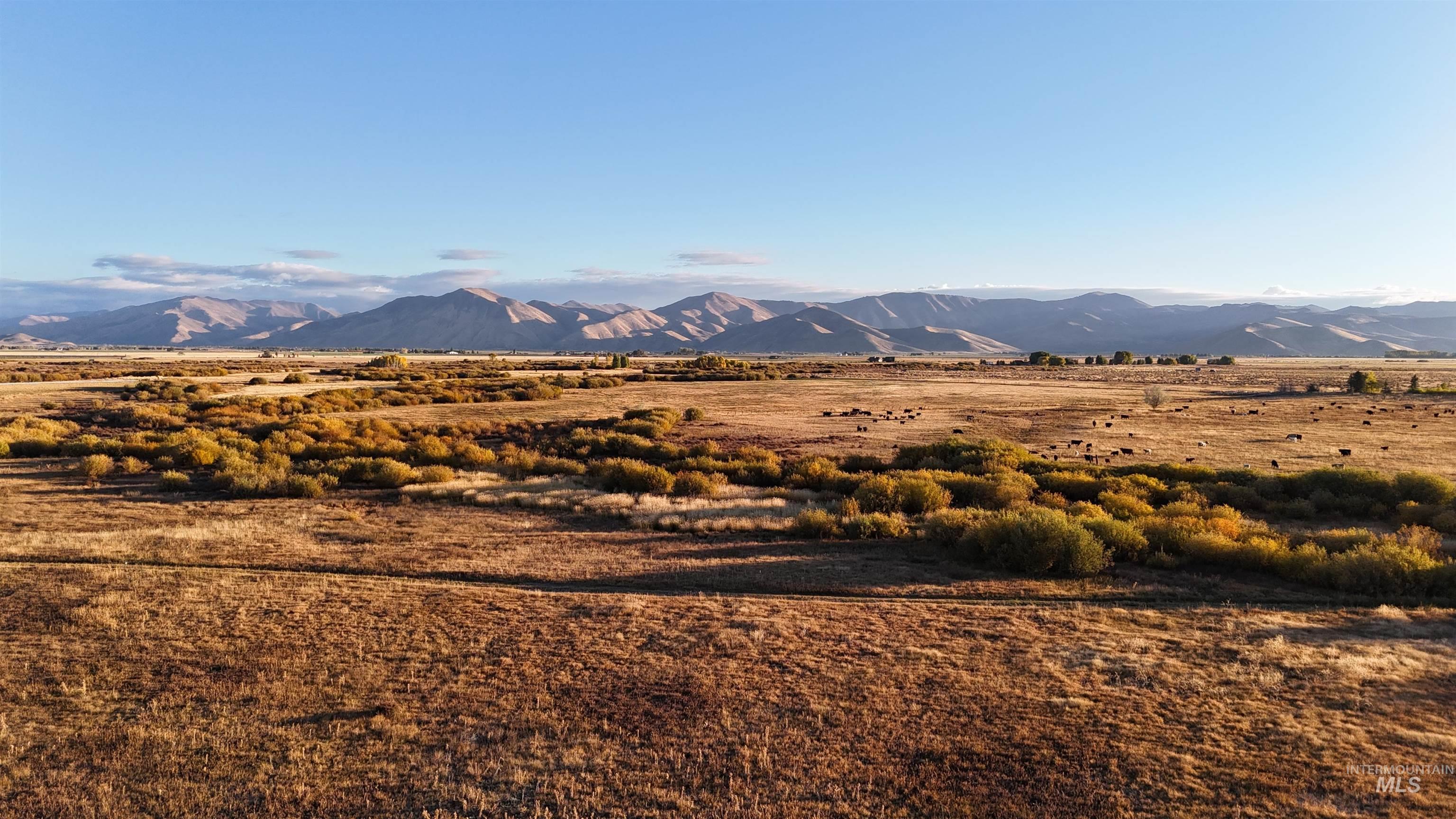 View of mountain backdrop with rural landscape