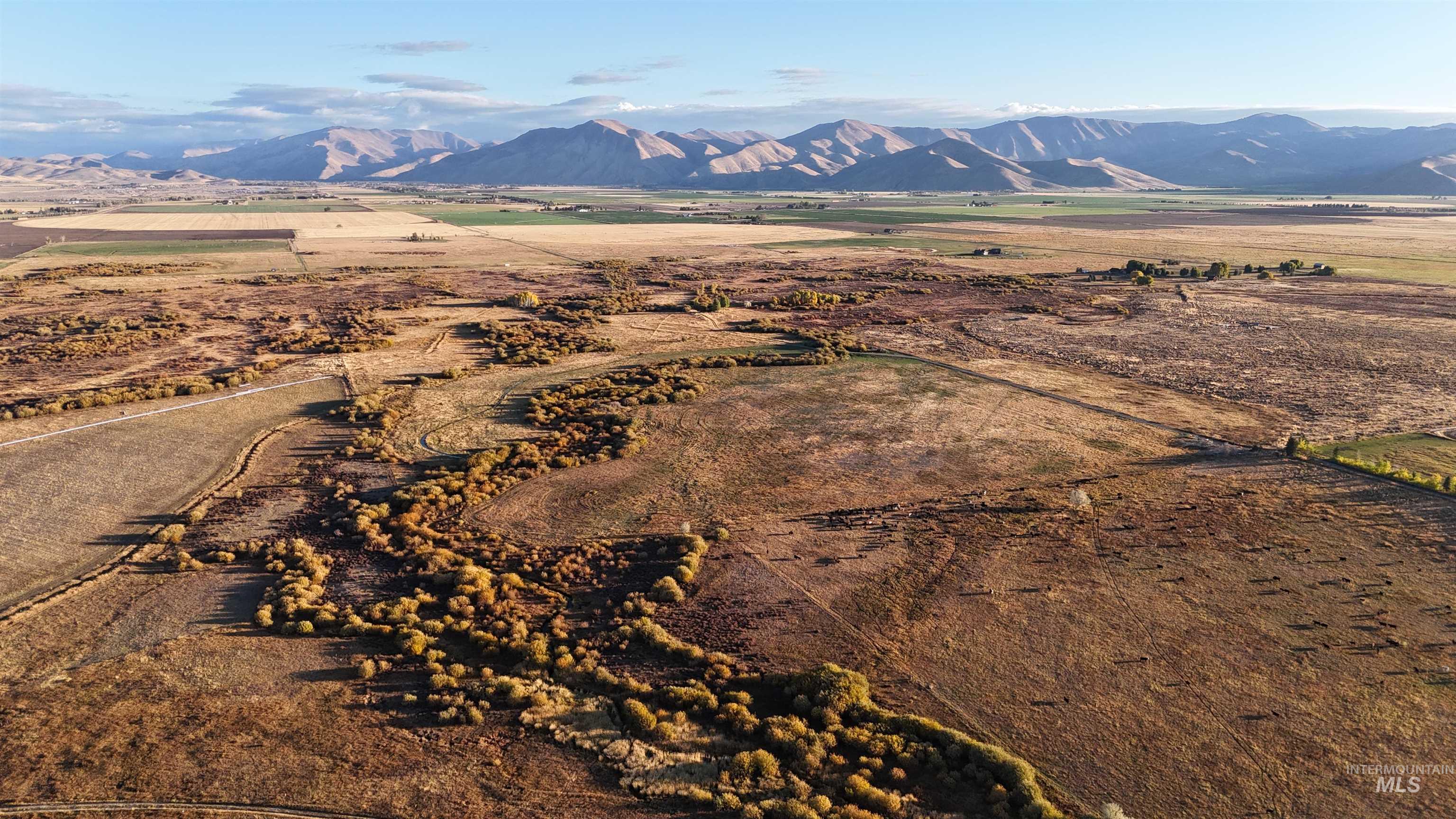 View of mountain backdrop with rural landscape