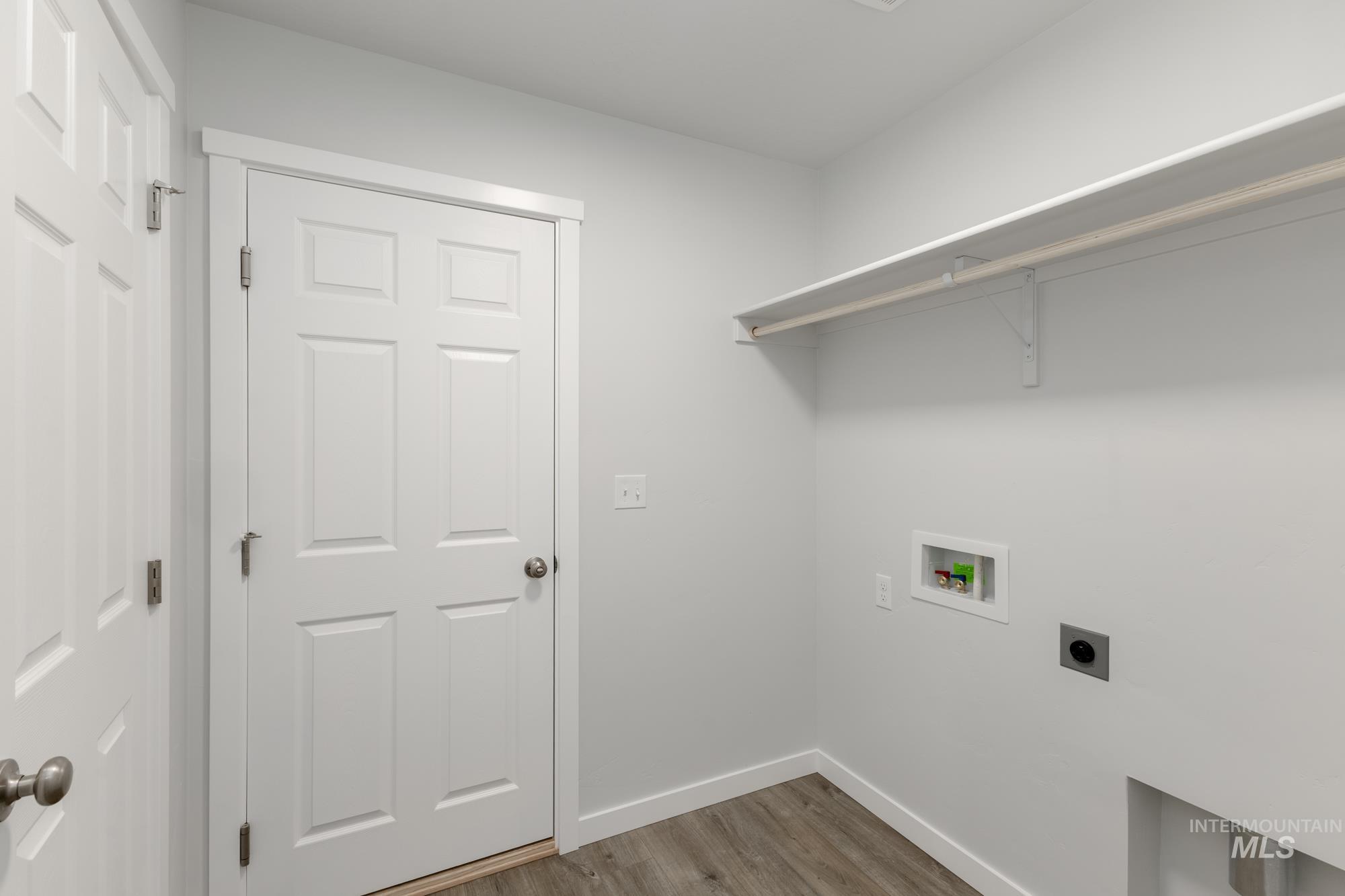 Laundry area featuring light wood-style floors, washer hookup, and hookup for an electric dryer