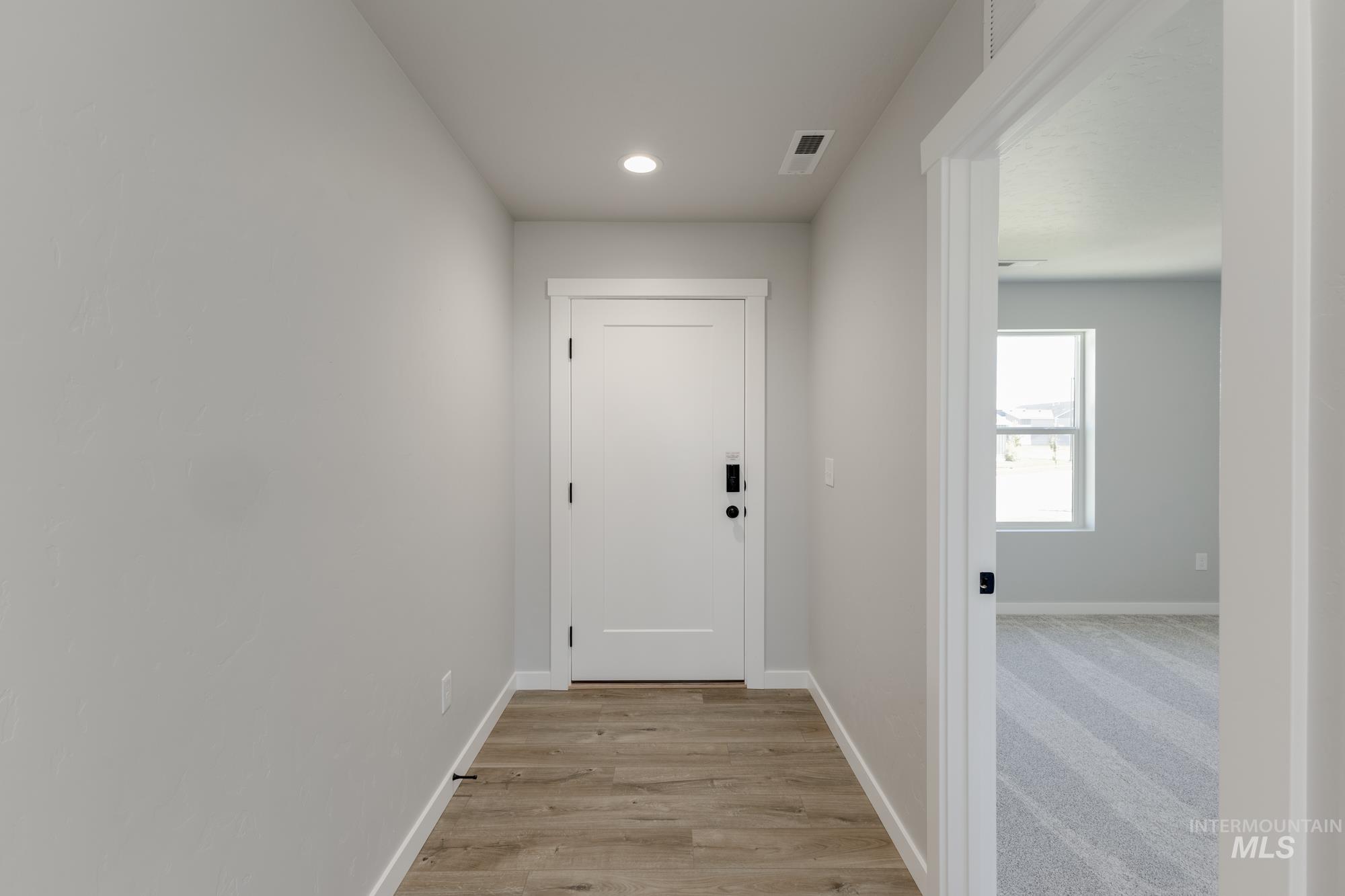 Corridor featuring recessed lighting and light wood-type flooring