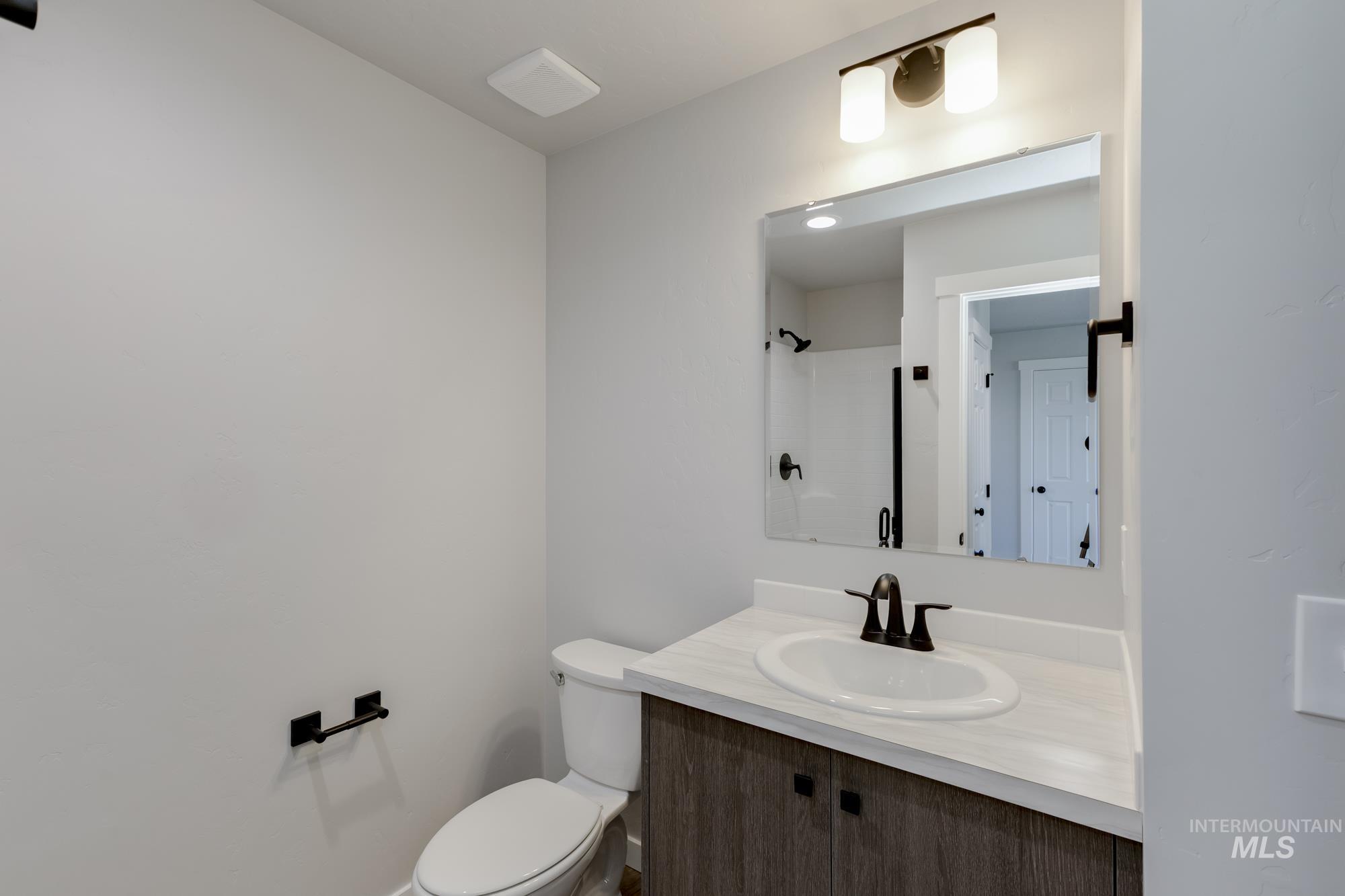 Full bath with vanity and a shower