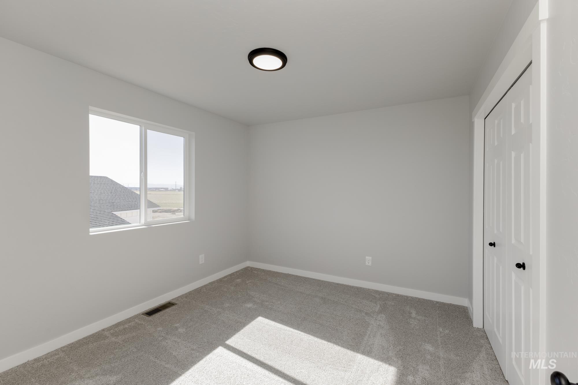 Unfurnished bedroom featuring carpet and a closet