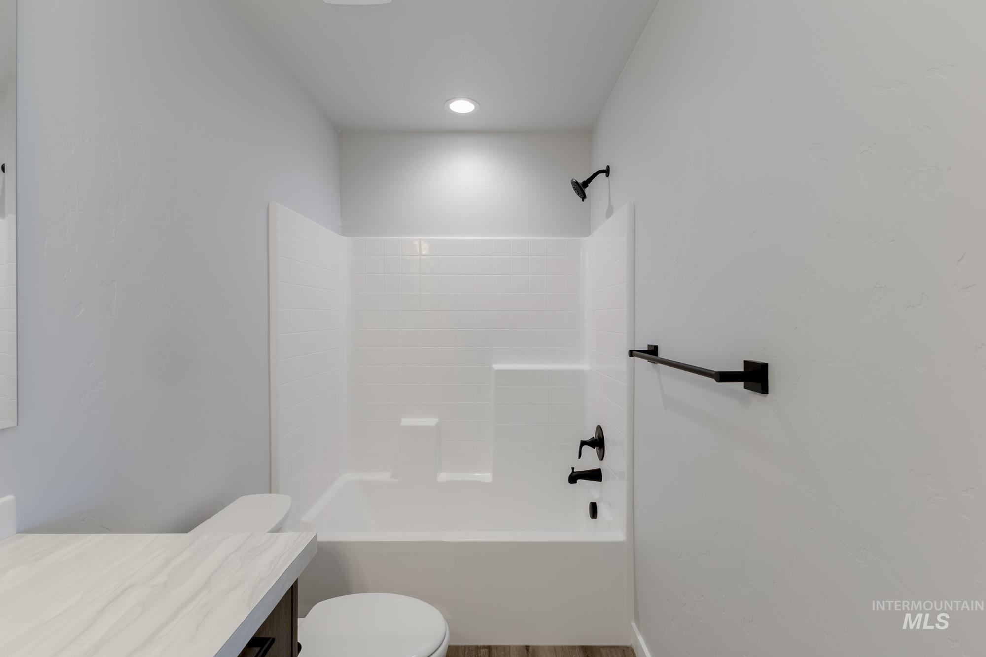 Bathroom with vanity, shower / washtub combination, and light wood-style floors