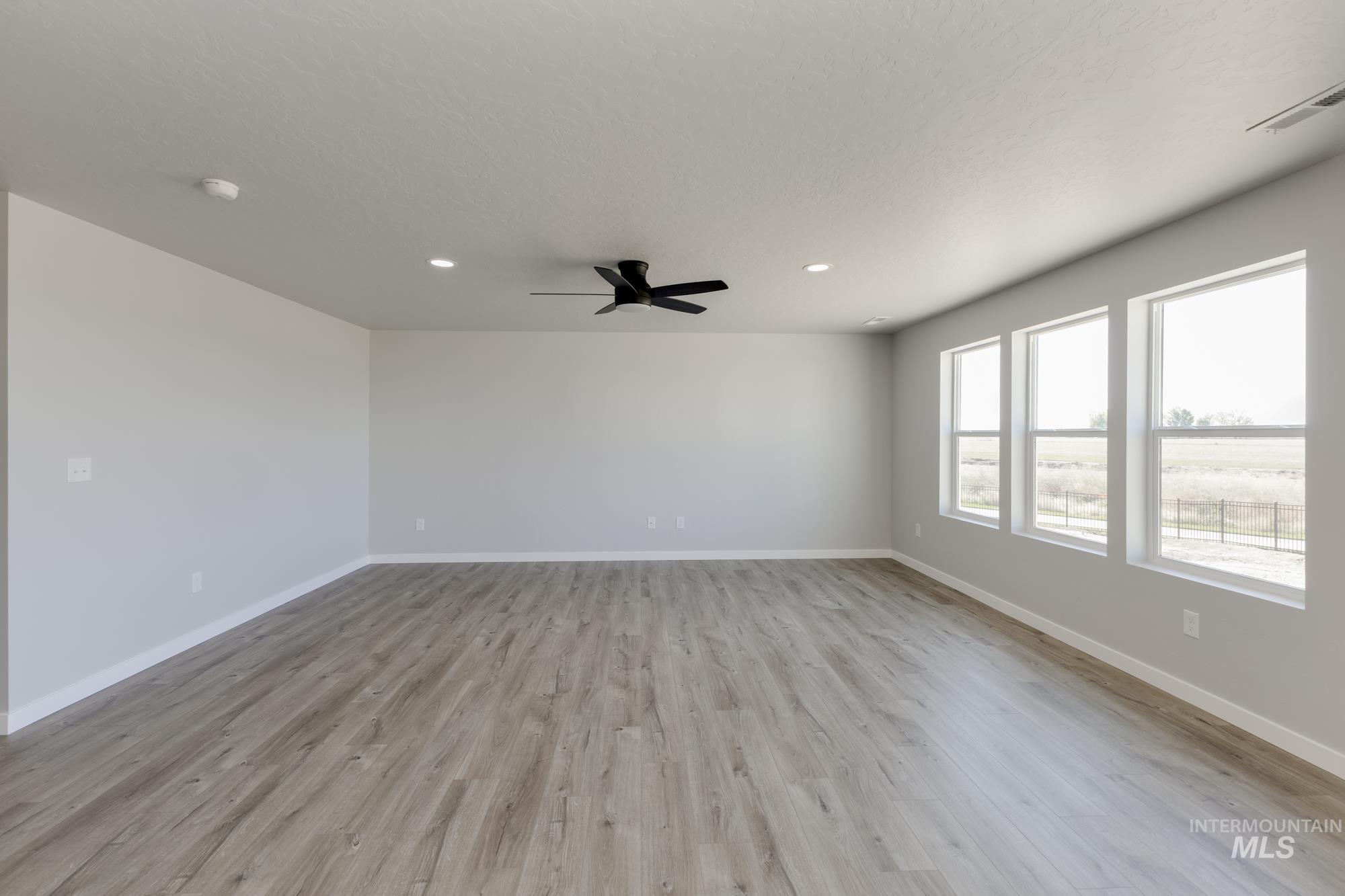 Spare room with light wood-type flooring, recessed lighting, and ceiling fan
