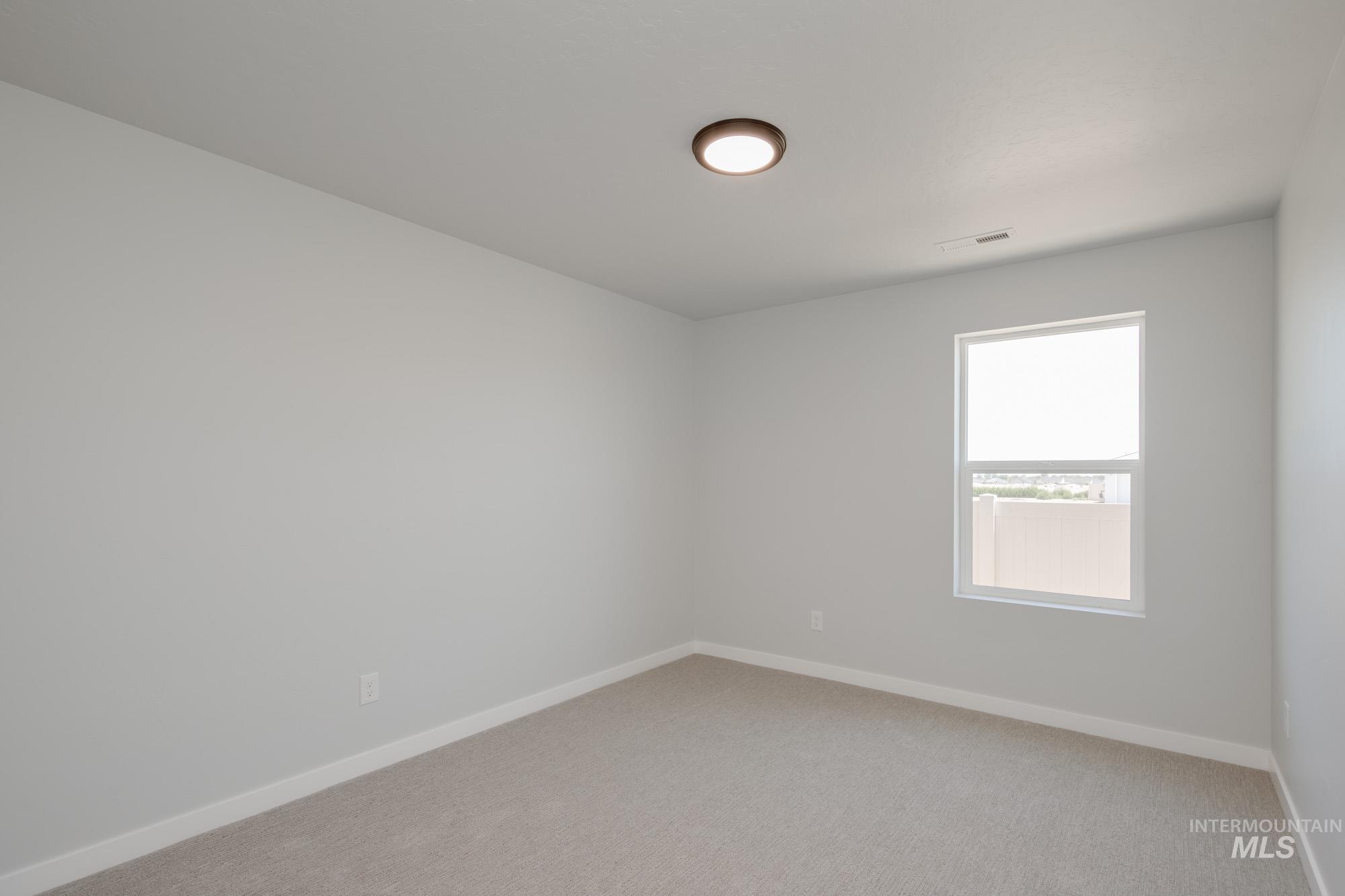 Unfurnished room with light carpet and baseboards