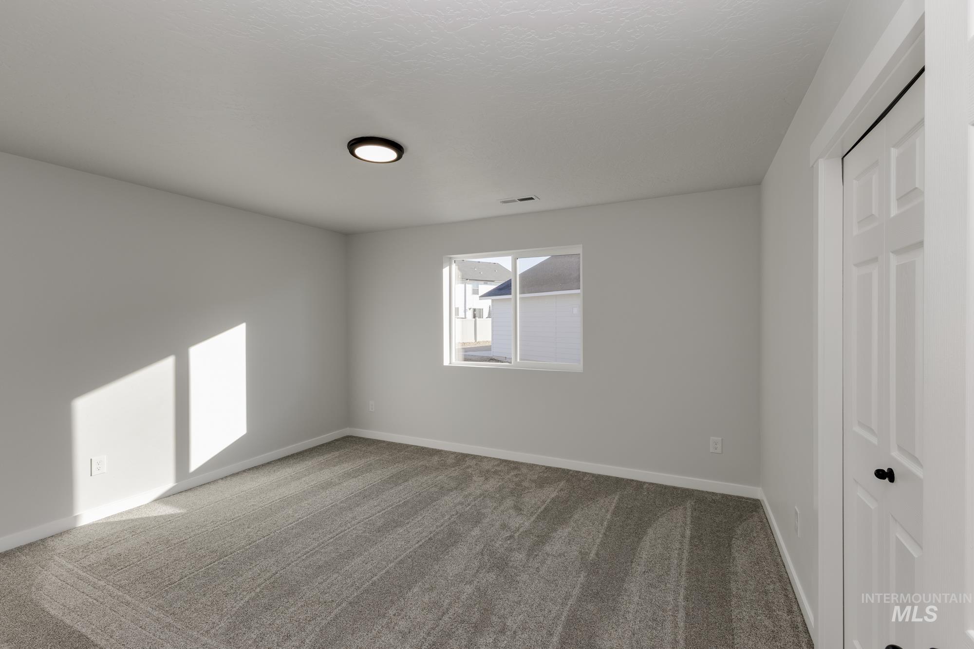 Unfurnished bedroom featuring carpet flooring and a closet