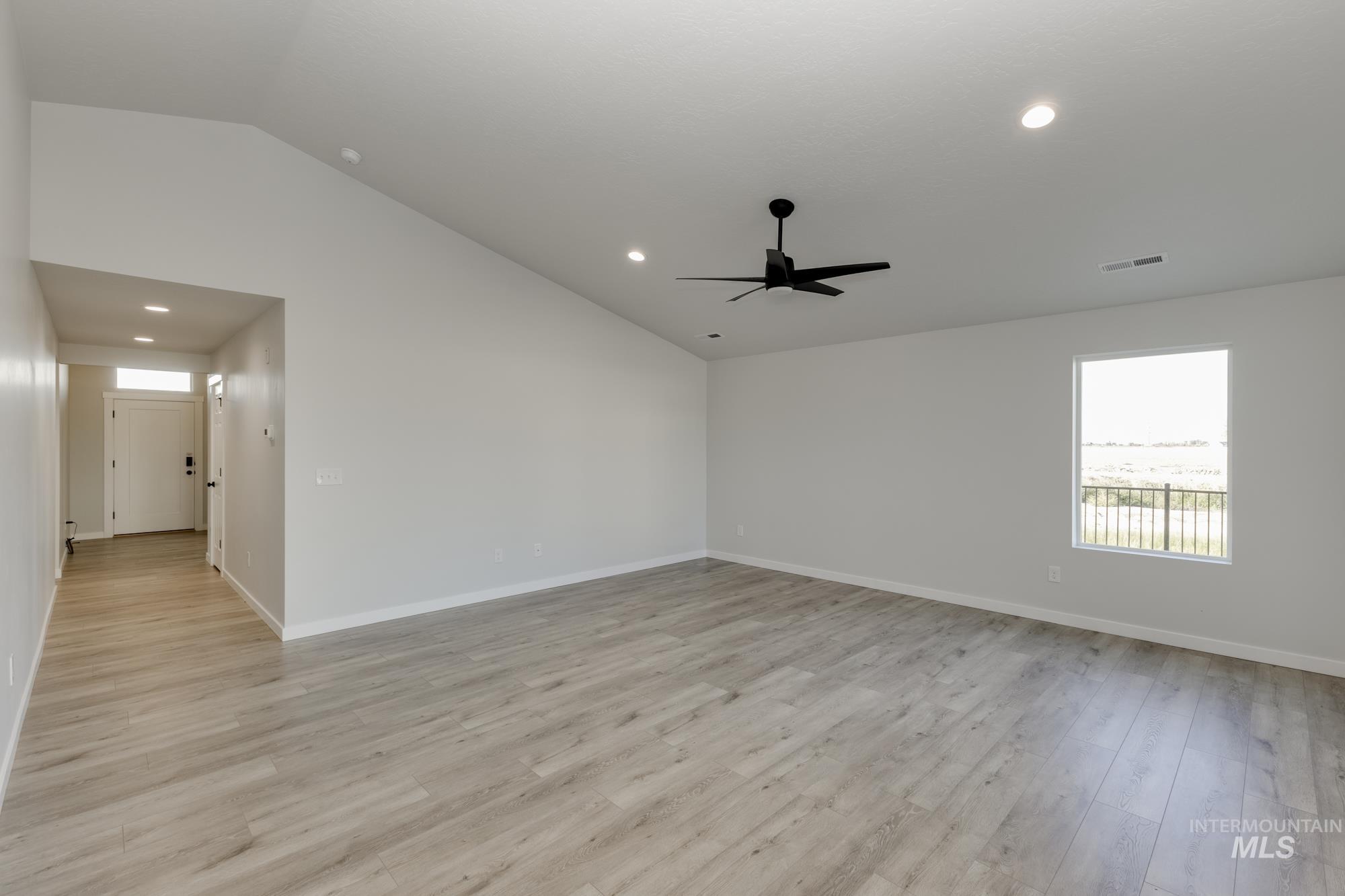 Unfurnished room featuring vaulted ceiling, recessed lighting, light wood finished floors, and ceiling fan