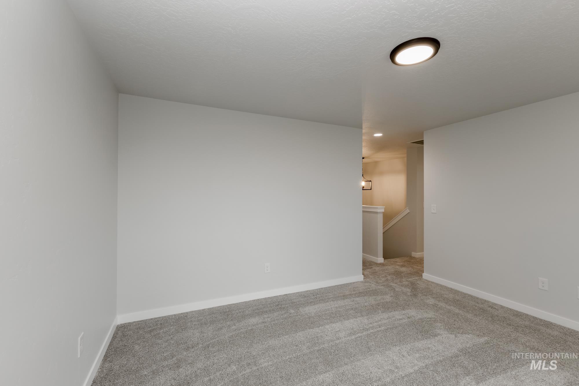 Unfurnished room with light carpet and recessed lighting