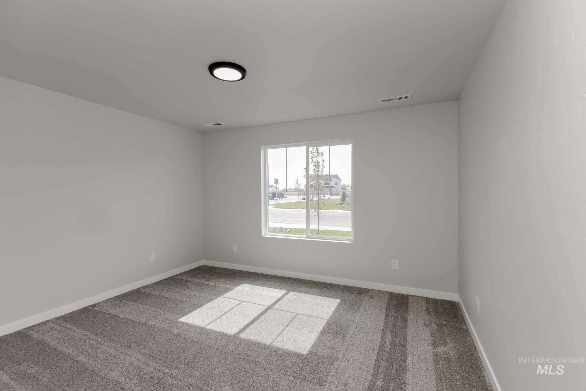 Unfurnished room featuring light carpet