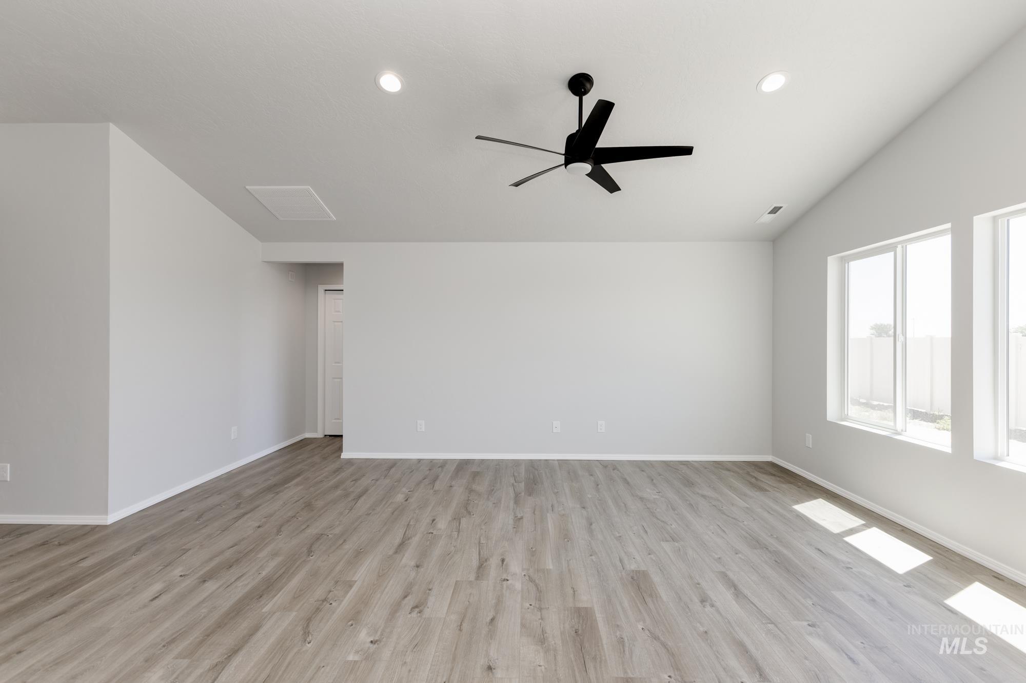 Unfurnished room with light wood-type flooring, lofted ceiling, recessed lighting, and ceiling fan