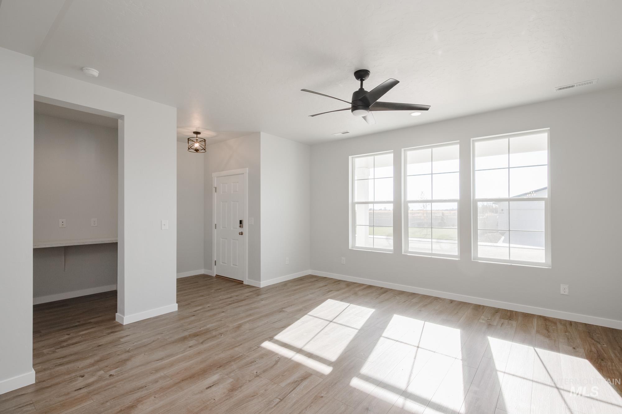 Unfurnished room with light wood-style flooring and ceiling fan